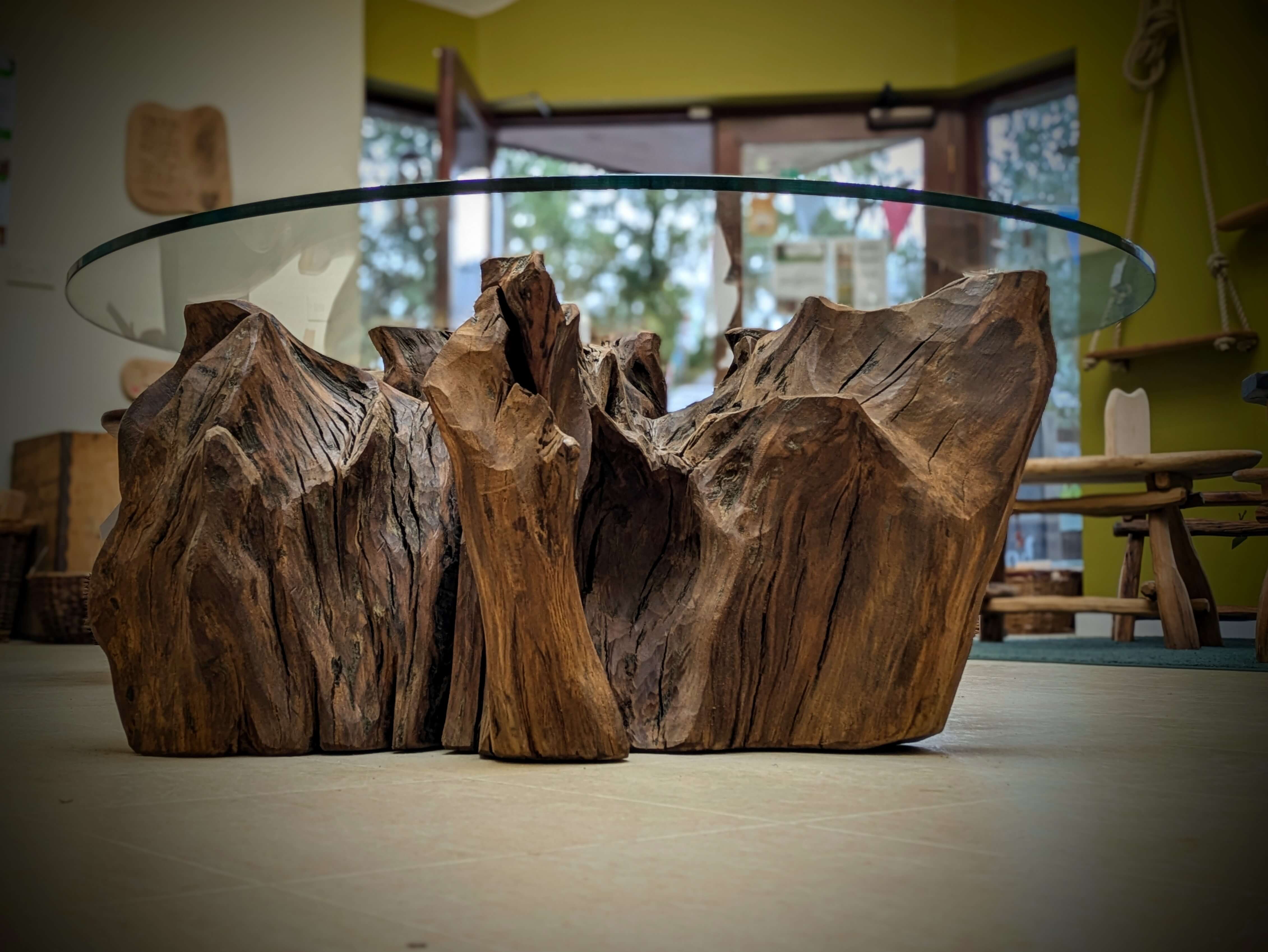 A reclaimed Oak Stump Table, with a glass top 