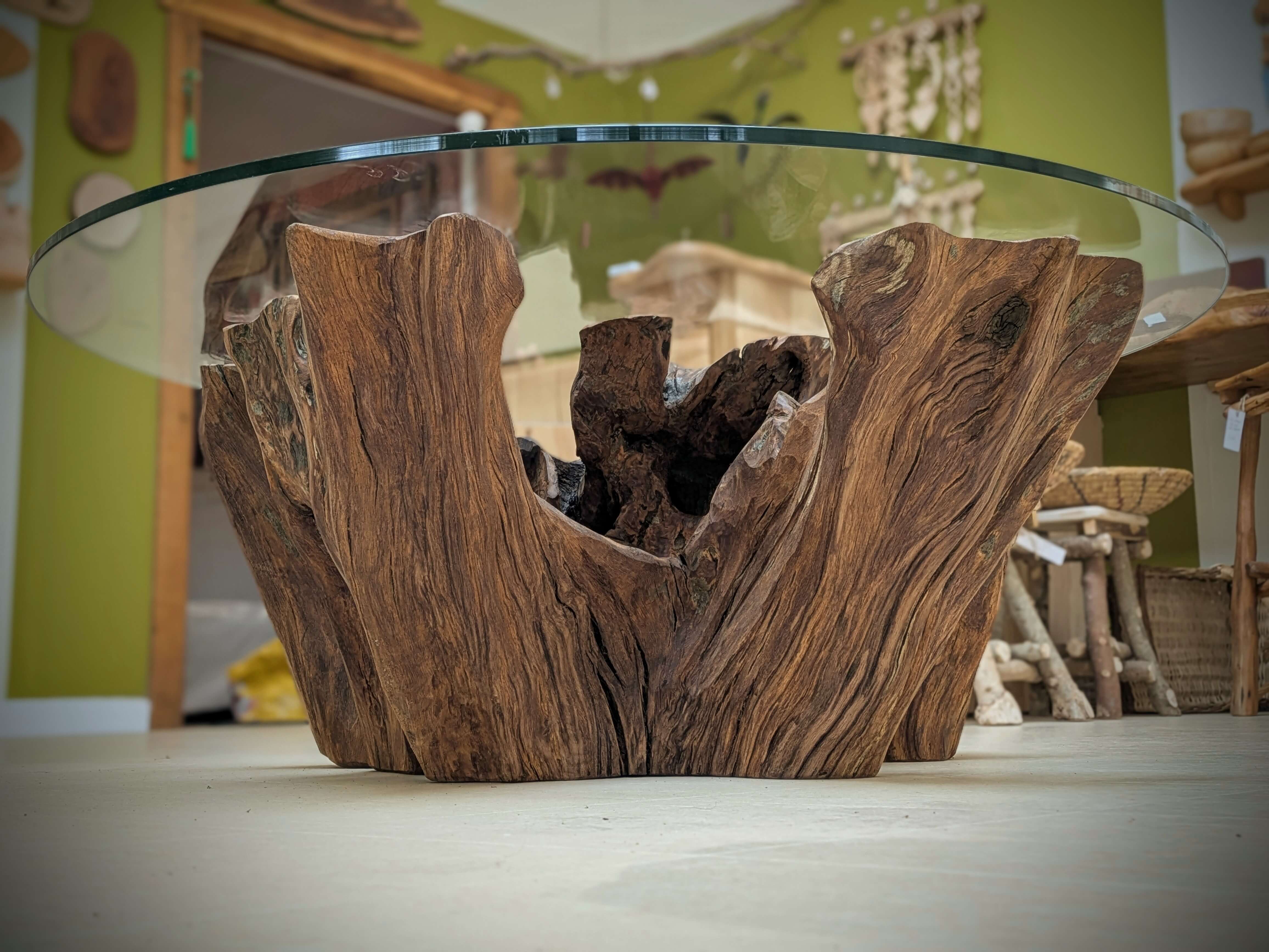 A reclaimed Oak Stump Table, with a glass top 