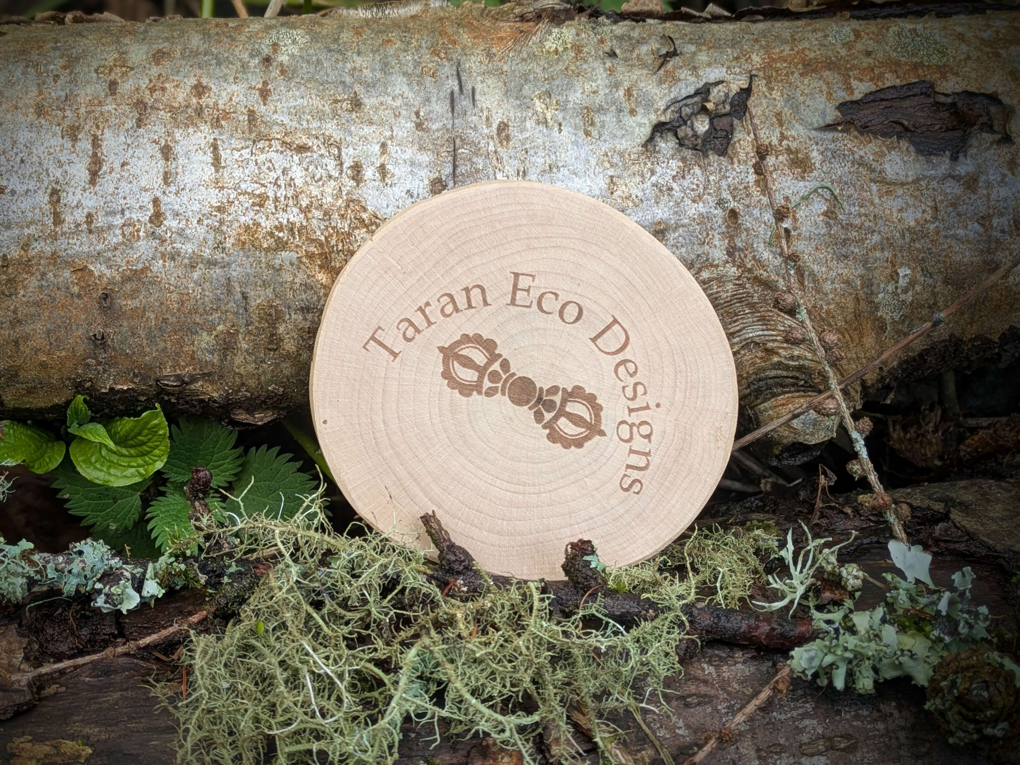 Round wooden coaster with 'Taran Eco Designs' logo on a natural background