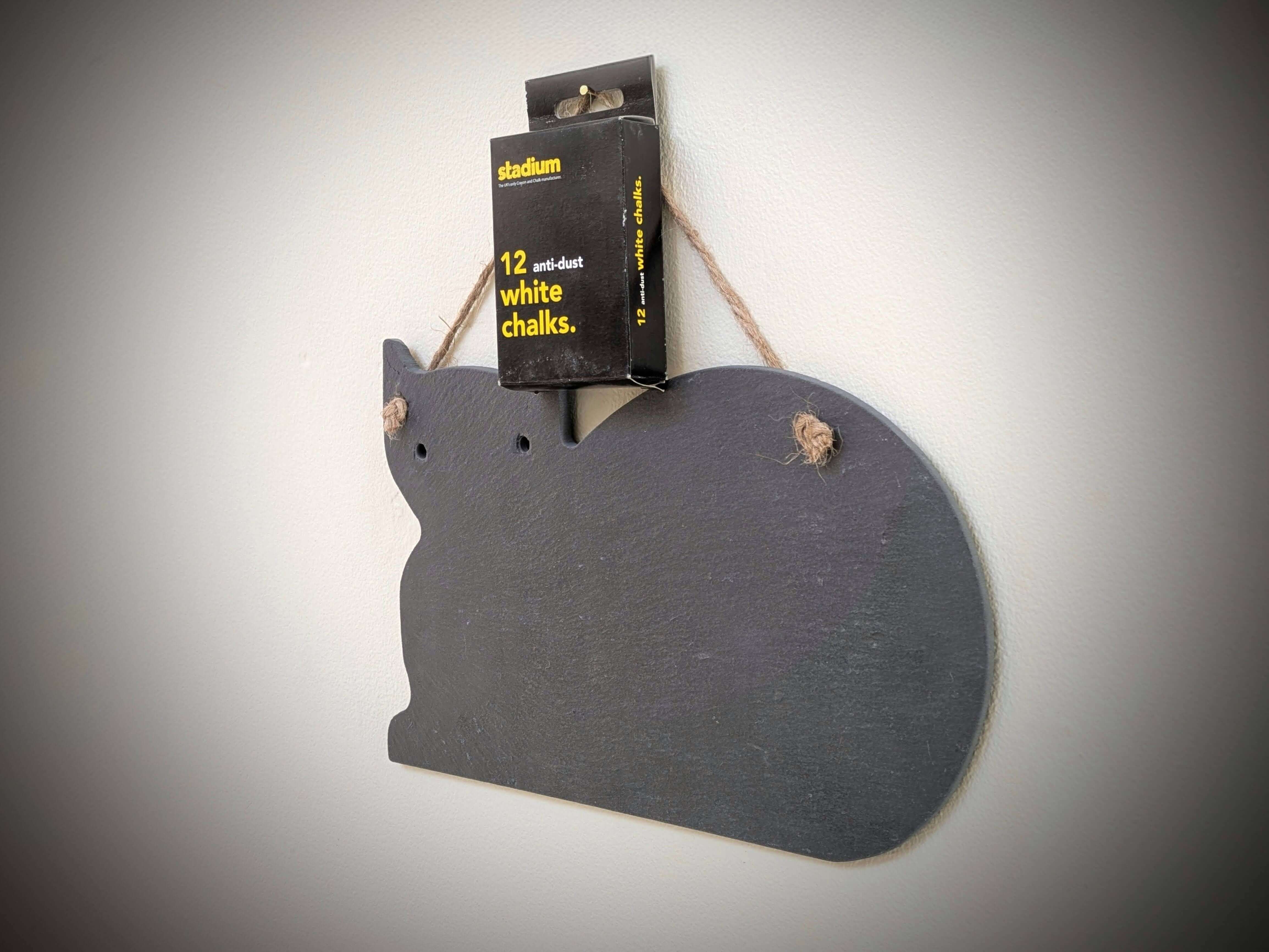 Cat-shaped chalkboard with a box of chalk on a gray background